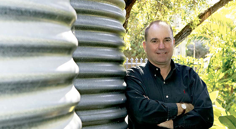 Conjoint Associate Professor Peter Coombes with his household rainwater tanks made from AQUAPLATE® steel.