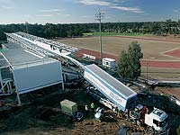 BlueScope Lysaght’s mobile
roll former tilts up to produce the 103 metre lengths of roof cladding for the Blacktown Olympic Park grandstand.