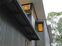 This family holiday home at Pindimar Bay on the north shore of Port Stephens, New South Wales uses LYSAGHT CUSTOM ORB® roofing and wall cladding in colours Jasper®, Dune® and Ironstone®.