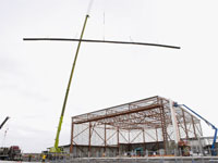 On-site rollforming allows the production of a single sheet of cladding to cover the entire length of a roof