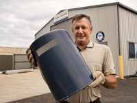 Eric Marsh of Marco Roofing with an industrial gutter guard. Marco Roofing participates in the STEEL BY&trade; Brand Partnership Program