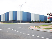 The striking walls of the SPC Ardmona warehouse in Shepparton are clad in LYSAGHT CUSTOM ORB&reg; sheet sheeting.