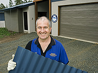 John Franklin of Franklin Constructions, a member of the STEEL BY&trade; Brand Partnership Program, outside one of his company's homes featuring wall cladding made from COLORBOND&reg; steel.