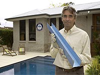 Illawarra Steel Frame Homes Managing Director David Sheehy, holding a piece of TRUECORE® steel