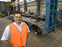 Jim Xidis of Brentwood Trailers, a member of the STEEL BY™ Brand Partnership Program, with a low loader