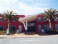 Canberra International Sports and Aquatic Centre (CISAC) - 3,000 square metres of LYSAGHT CUSTOM ORB® clads the facade, in spectacular stripes of Shale Grey™ and Deep Ocean® COLORBOND® steel.