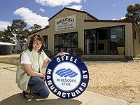 Leah Voigt from Meleah Kit Fabrications, a member of the STEEL BY&trade; Brand Partnership Program, outside a shed using the American barn design.