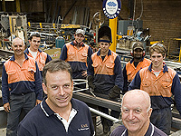 Ian Mitchell (left), his father Ken, and the team from Ken Mitchell Engineering, a member of the STEEL BY&trade; Brand Partnership Program.