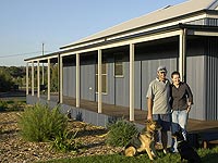 Matt Diamond and his wife Kim with their home which uses LYSAGHT CUSTOM ORB&reg;  cladding for its roof and external walls.