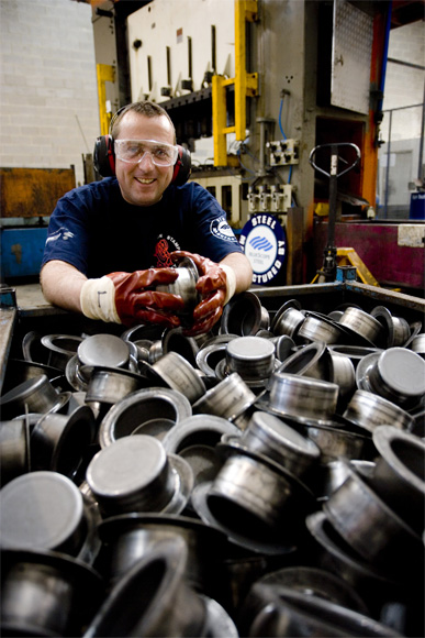 Lindsay Guscott displays some of the automotive components that Production Stamping Co fabricates. 