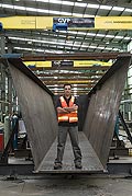 GVP Fabricators Pty Ltd General Manager, Nick Palamaras, with one of the huge trough girders fabricated from XLERPLATE? steel for Melbournes Eastlink motorway project. 
