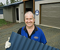 John Franklin of Franklin Constructions, a member of the STEEL BY™ Brand Partnership Program, outside one of his company's homes featuring wall cladding made from COLORBOND® steel.