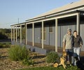 Matt Diamond and his wife Kim with their home which uses LYSAGHT CUSTOM ORB&reg;  cladding for its roof and external walls.