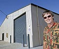 Jack Hunneman of Oz-Cover with a steel building his company manufactured in Logan Village, Queensland