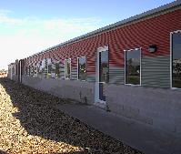 LYSAGHT CUSTOM ORB&reg; walling made from COLORBOND&reg; steel in the colours Headland&reg; and Pale Eucalypt&reg; at the Swan Hill campus of the Sunraysia TAFE college, Victoria.