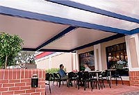 Several fast food stores in Sydney are erecting erecting awnings made from APS Versiclad, which combine an exterior of profiled COLORBOND&reg; steel in colour Dune&reg;, with a polystyrene insulation core and a clean, white, stucco embossed steel ceiling face