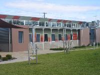 LYSAGHT CUSTOM ORB&reg; walling made from COLORBOND&reg; steel in the colours Headland&reg; and Pale Eucalypt&reg; at the Swan Hill campus of the Sunraysia TAFE college, Victoria.